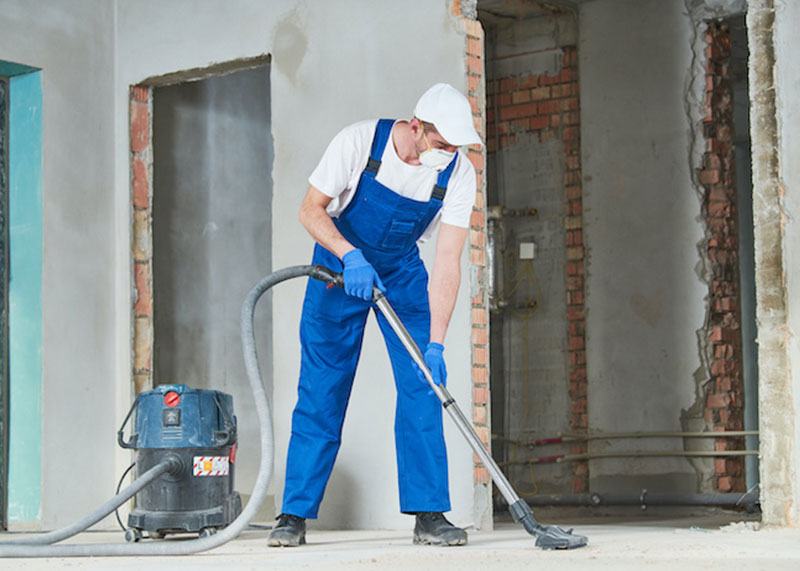 “Green” Cleaning Solutions project with Mac's employee vacuuming post construction office facility