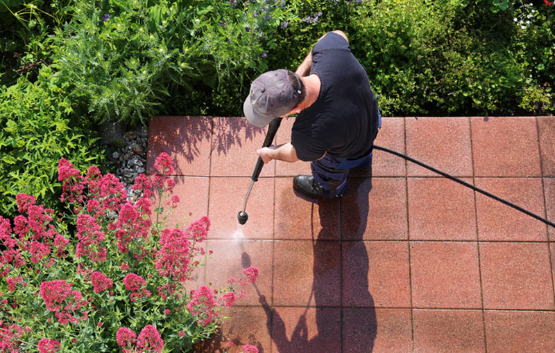 Exterior Grounds Maintenance project of janitor power washing sidewalk