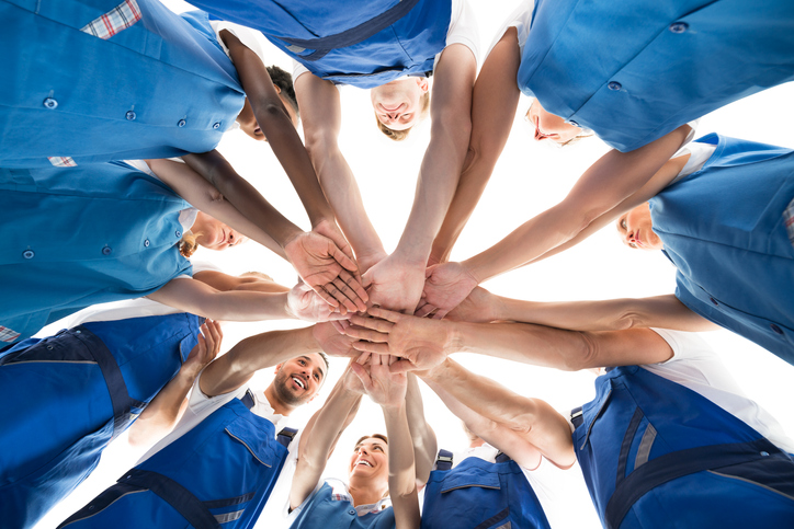 Mac's janitors in circle connecting hands