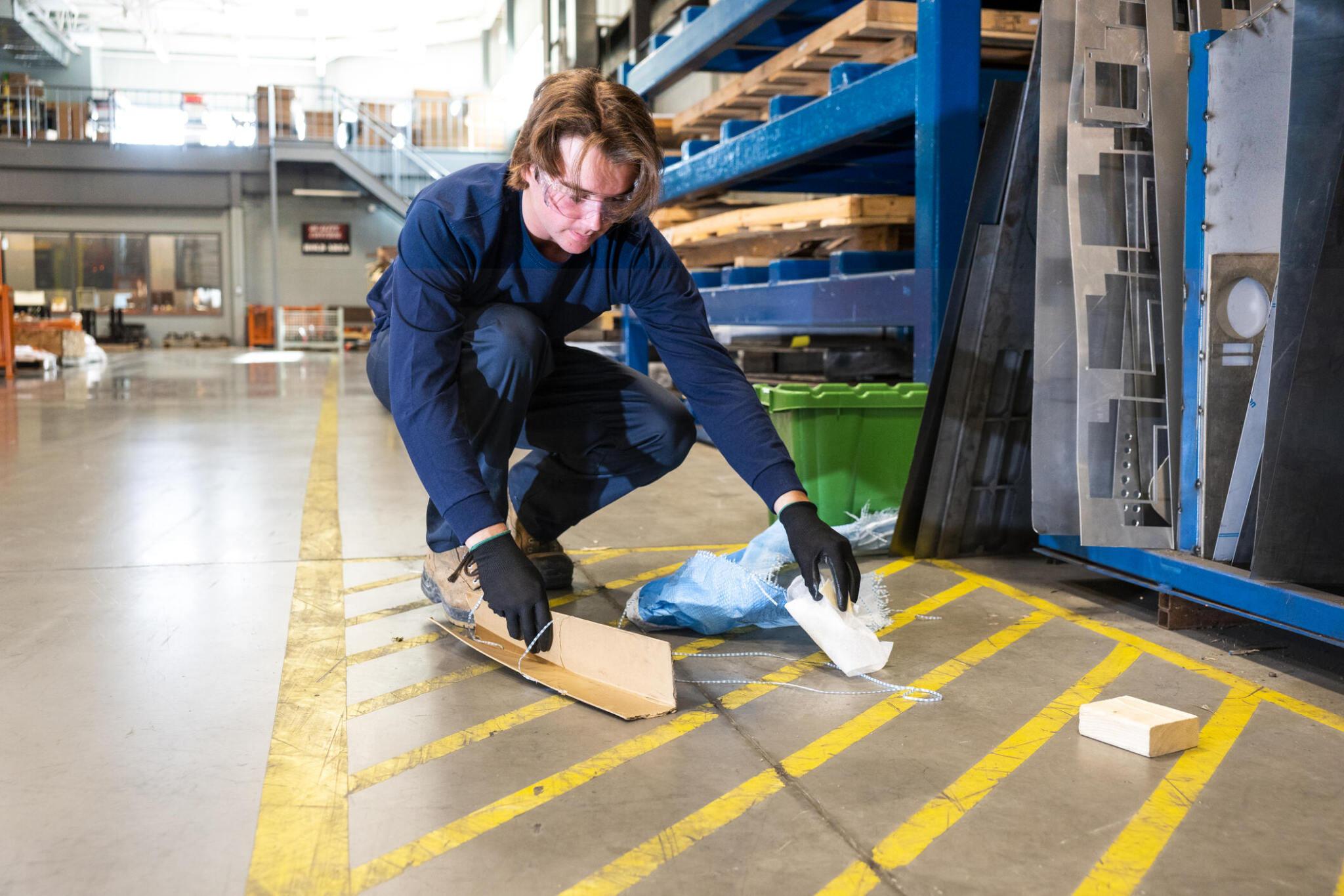 Janitor cleaning floor space in warehouse and distribution center