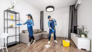 Man and woman cleaning staff and janitor moping hardwood floors