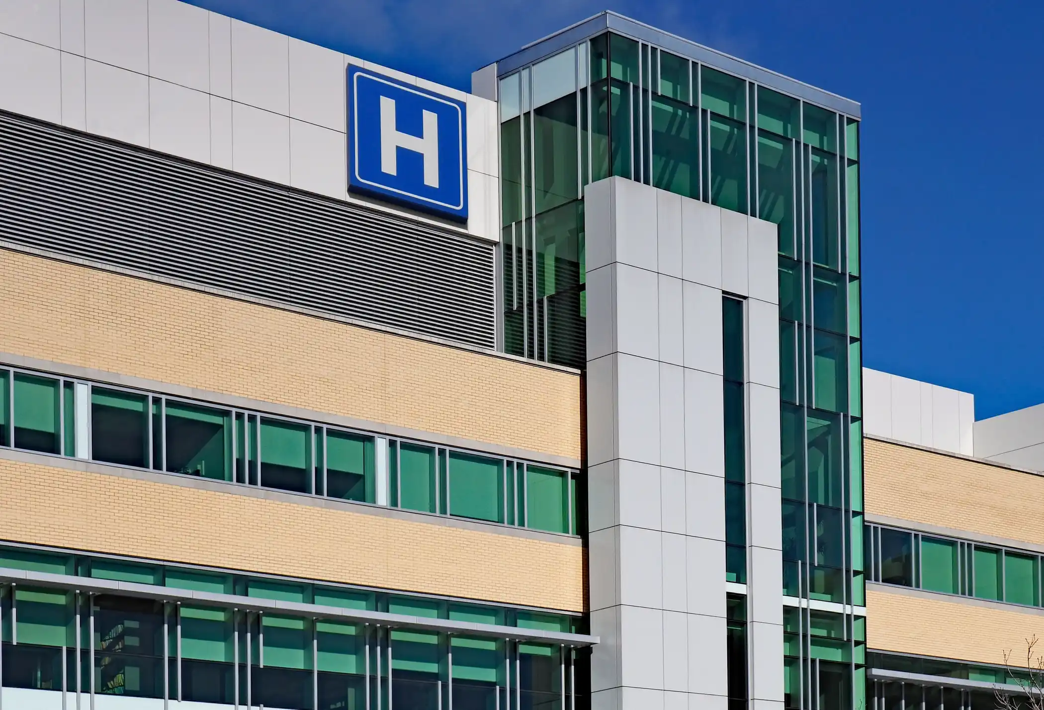 Outside shot of hospital building with elevator and H symbol on top