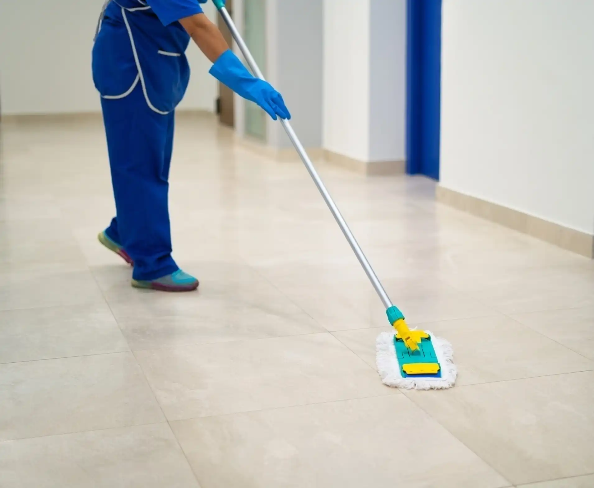 Janitor cleaning floor with a dust mop