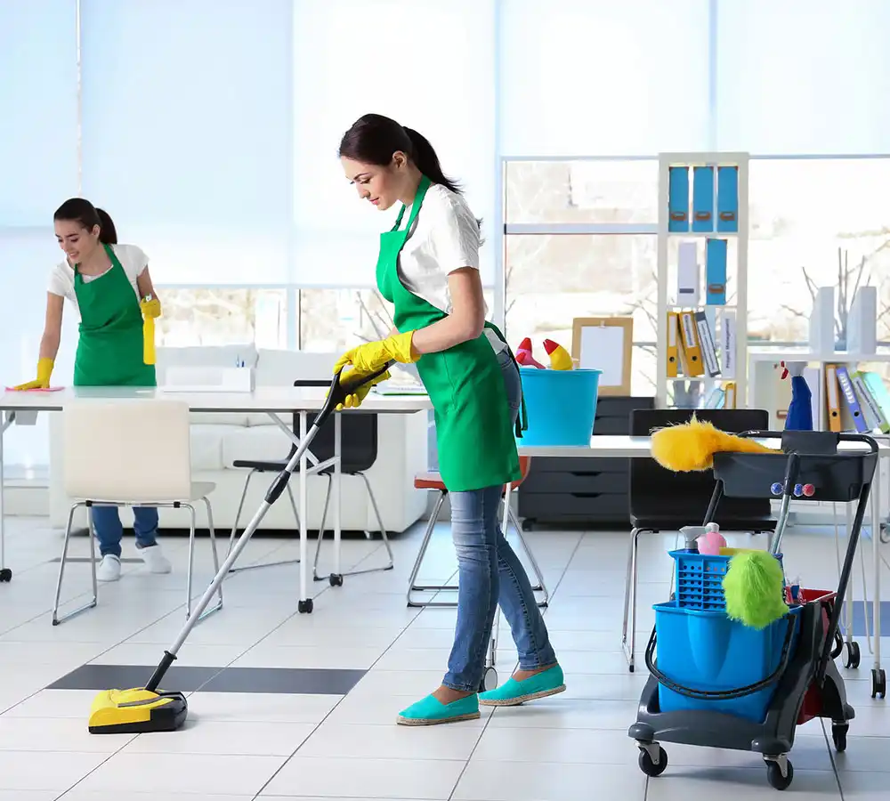 Women cleaning and mopping floor of office
